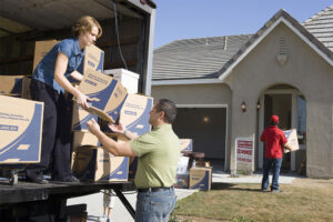 Man and Woman Unloading Truck of Cardboard Boxes — Chicago, IL — Affordable Moving Company, Inc.