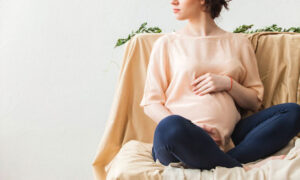 Pregnant Woman Sitting on Couch — Chicago, IL — Affordable Moving Company, Inc.